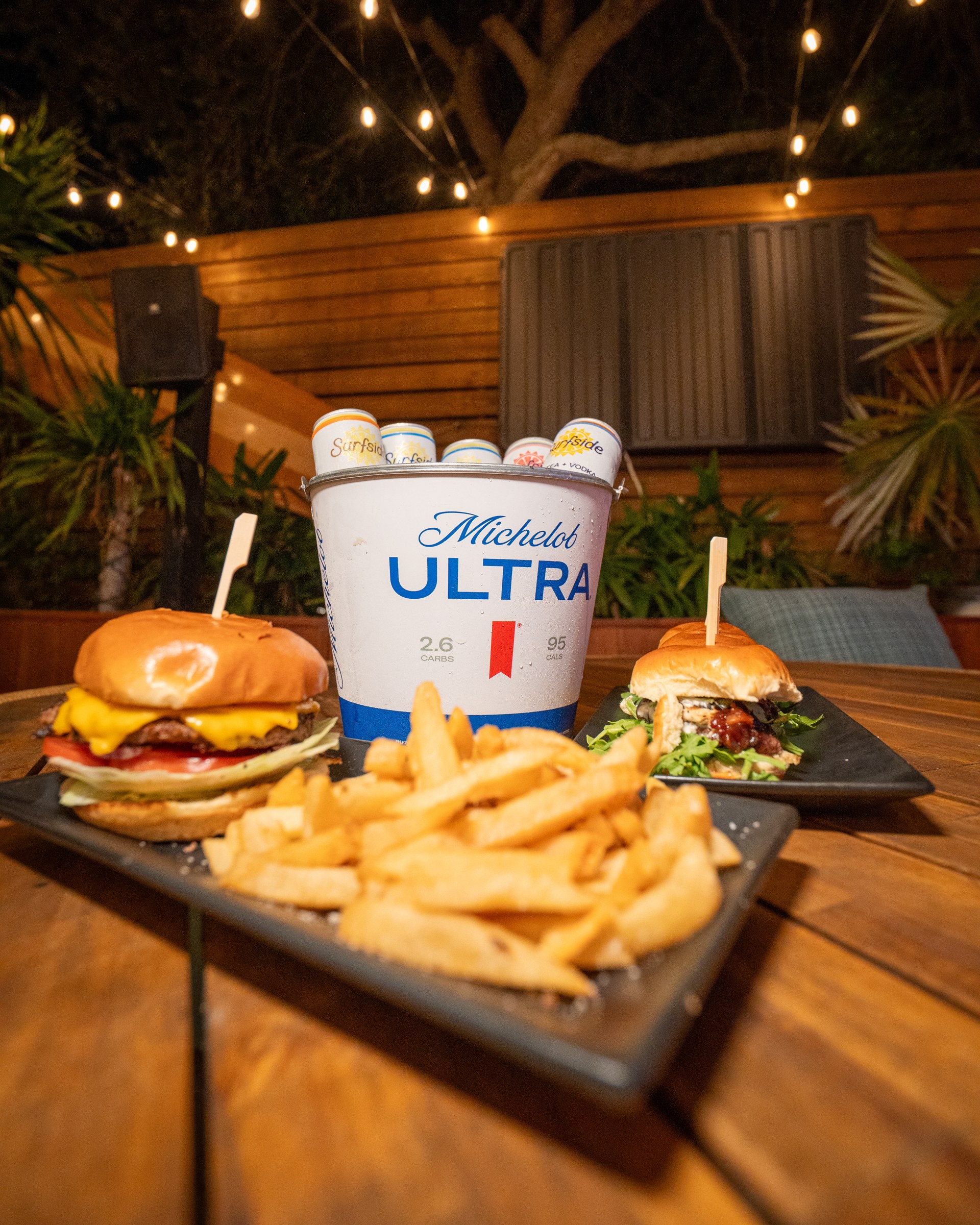 Burgers, fries, and a bucket of drinks on The Standard’s outdoor patio